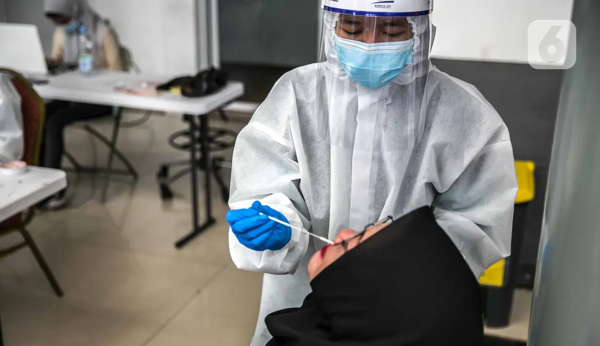 Calon penumpang menjalani swab antigen di Stasiun Senen, Jakarta, Senin (21/12/2020). Penumpang kereta api jarak jauh menunjukkan surat bebas Covid-19 dengan melakukan tes PCR atau tes rapid antibodi yang masih berlaku 14 hari sejak diterbitkan. (Liputan6.com/Faizal Fanani)