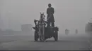 Seorang lelaki menunggang kuda di tengah kondisi kabut asap tebal di Lahore, Pakistan (21/11/2019). Lahore pada hari Kamis (21/11) menduduki peringkat global untuk kota dengan kualitas udara terburuk dan berbahaya. (AFP Photo/Arif Ali)