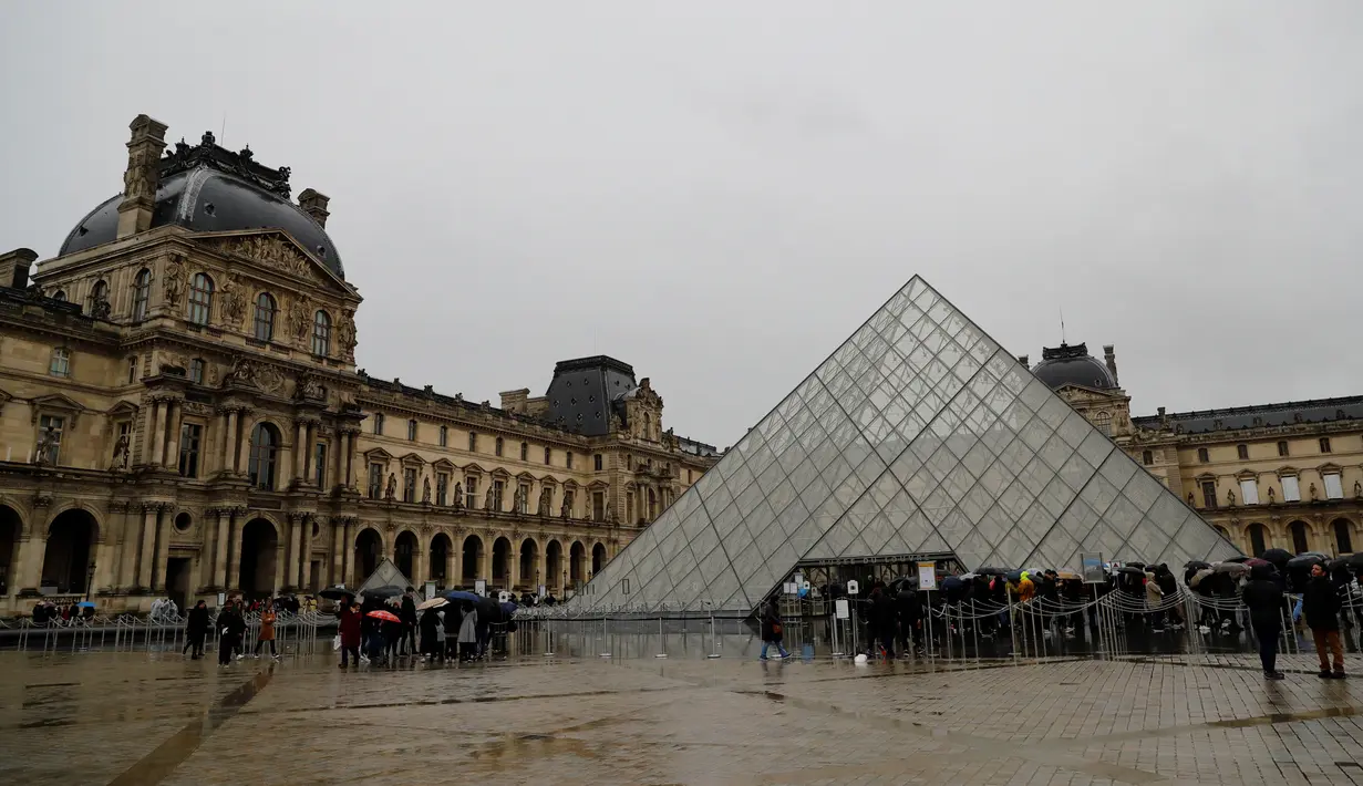 <p>Orang-orang mengantre di depan Louvre Pyramide di Paris pada Minggu (1/3/2020). Louvre, museum yang paling banyak dikunjungi di dunia, ditutup sementara untuk pengunjung setelah para staf mengutarakan kecemasan dan ketakutannya tertular virus corona tipe baru, Covid-19. (Thomas SAMSON/AFP)</p>