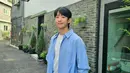 Jung Hae In di sini tampil memesona dengan kaus putih, kemeja biru lengan panjang, dan padu padan mengenakan celana jeans. [Foto: Instagram/holyhaein]