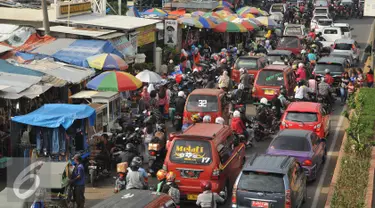 Sejumlah kendaraan berjalan merayap saat melintasi Pasar Tumpah di Cikarang, Jawa Barat, Jumat (1/7). Selain banyaknya persimpangan, keberadaan Pasar Tumpah menjadi salah satu penyebab kemacetan di Jalur Pantura. (Liputan6.com/Gempur M Surya)