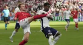 Bek Inggris Marc Guehi berebut bola dengan gelandang Denmark Mikkel Damsgaard dalam matchday 2 Grup C Euro 2024 di Deutsche Bank Park, Kamis (20/06/2024). (AP Photo/Thanassis Stavrakis)