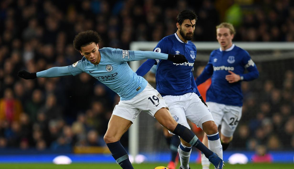 Leroy Sane melewati Andre Gomez pada laga lanjutan Premier League yang berlangsung di stadion Goodison Park, Liverpool, Kamis (7/2). Manchester City menang 2-0 atas Everton. (AFP/Paul Ellis)