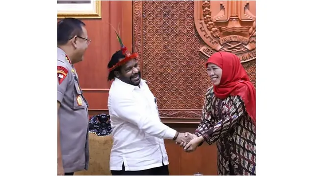 Gubernur Khofifah bertemu dengan Staf Khusus Presiden untuk daerah Papua, Ia terlihat menawan dengan batik berwarna coklat tua yang dipadukan dengan kerudung merah.