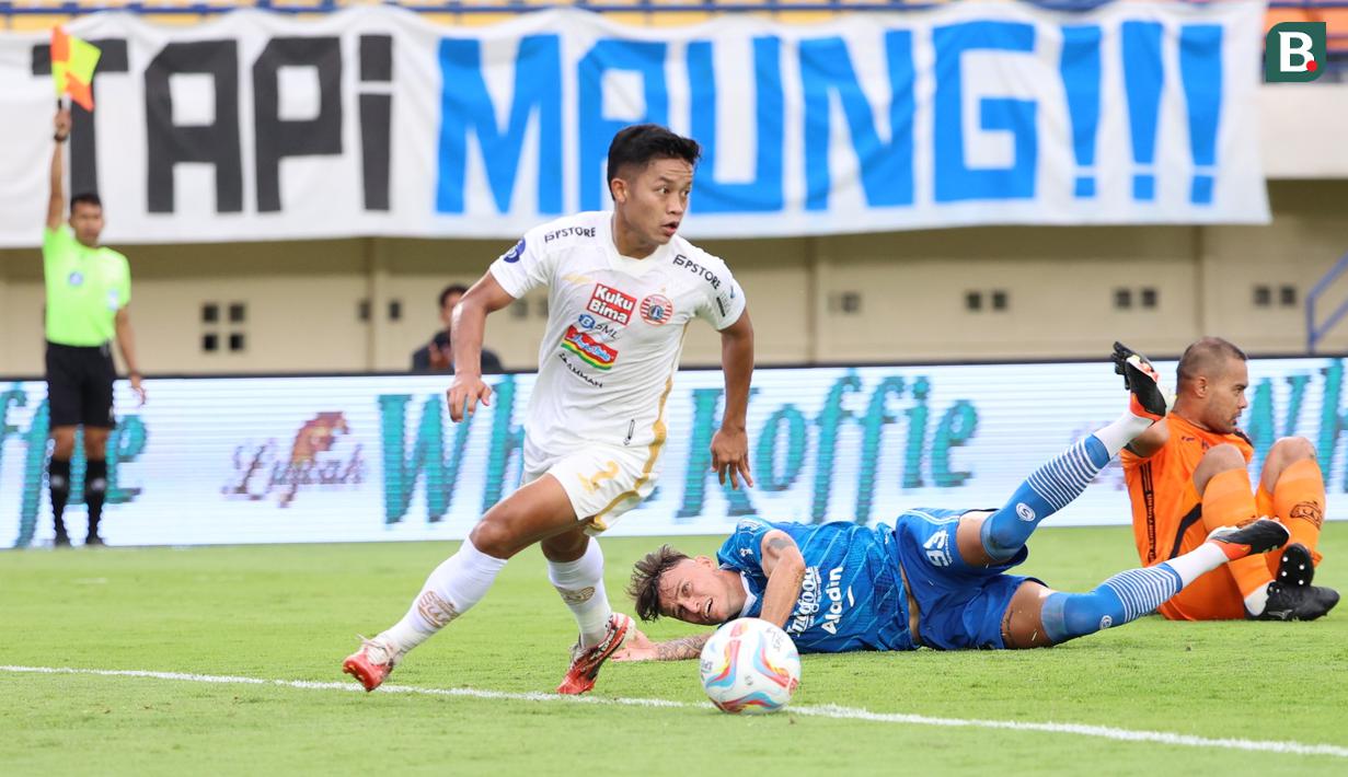 Pemain Persib Bandung, Stefano Beltrame, terjatuh saat berusaha melewati kiper Persija Jakarta, Andritany Ardhiyasa, pada laga pekan ke-28 Liga 1 2023/2024 di Stadion Si Jalak Harupat, Bandung, Sabtu (9/3/2024). (Bola.com/M Iqbal Ichsan)