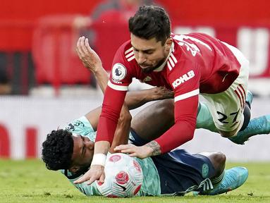 Manchester United gagal meraup poin penuh kala menjamu Leicester City pada pekan ke-31 Liga Inggris, Sabtu (2/4/2022). (AP/Jon Super)