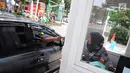 Pengendara mobil memberikan tiket parkir ke petugas di parkiran IRTI kawasan Monas, Jakarta, Jumat (11/1). Pemerintah DKI Jakarta mencabut insentif parkir kendaraan ASN atau PNS di IRTI Monas, Jakarta Pusat. (Liputan6.com/Herman Zakharia)
