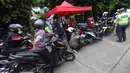 Pengujian ini untuk memastikan kendaraan memenuhi standar ramah lingkungan, dengan memeriksa kadar karbon monoksida (CO), hidrokarbon (HC), dan nitrogen oksida (NOx). Tampak dalam foto, antrean motor yang akan melakukan pengukuran gas buang saat operasi uji emisi di Pintu Keluar Terminal Blok M, Jakarta, Kamis (9/4/2026). (Kapanlagi.com/Budy Santoso)