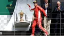 Gaya pembalap Ferrari, Sebastian Vettel saat menaiki podium setelah memenangkan F1 GP di Sirkuit Silverstone, Inggris, Minggu (8/7). Vettel mengungguli Lewis Hamilton dan Kimi Raikkonen. (AP Photo/Luca Bruno)