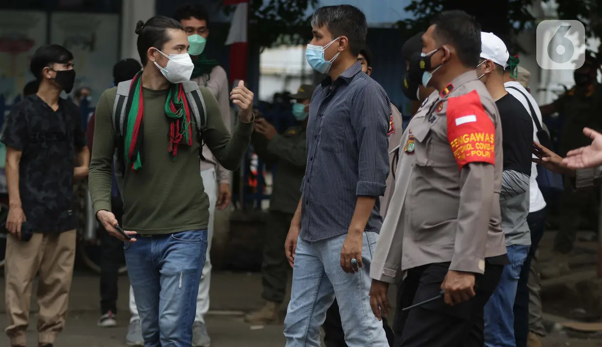 Polisi membubarkan aksi unjuk rasa pencari suaka asal Afghanistan di depan Kantor UNHCR, Jalan Kebon Sirih, Jakarta, Selasa (24/8/2021). Aksi ini akhirnya dibubarkan pihak kepolisian karena menimbulkan kerumunan dan kemacetan di sekitar lokasi. (Liputan6.com/Helmi Fithriansyah)
