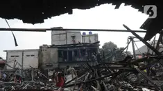 Warga mencari sisa barang akibat terbakar kios pasar Kambing, Jakarta, Rabu (9/8/2023). (merdeka.com/imam buhori)