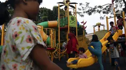 Anak-anak didampingi orangtua bermain di RPTRA Bhineka Jakarta Selatan, Sabtu (30/7/2022). Selain menjadi alternatif mengisi libur bersama keluraga, taman juga menjadi ruang bagi warga untuk berinteraksi sosial sekaligus mengeduksi anak untuk bermain bersama teman-teman dengan wahana yang tersedia. (Liputan6.com/Johan Tallo)