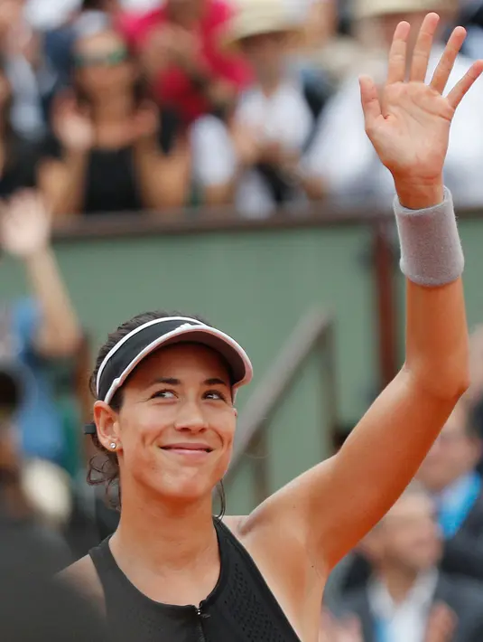 Petenis Spanyol Garbine Muguruza tersenyum usai pertandingan melawan petenis Rusia, Maria Sharapova di perempat final turnamen tenis Prancis Terbuka di stadion Roland Garros,  Prancis (6/6). Garbine menang 6-2, 6-1. (AP Photo/Christophe Ena)