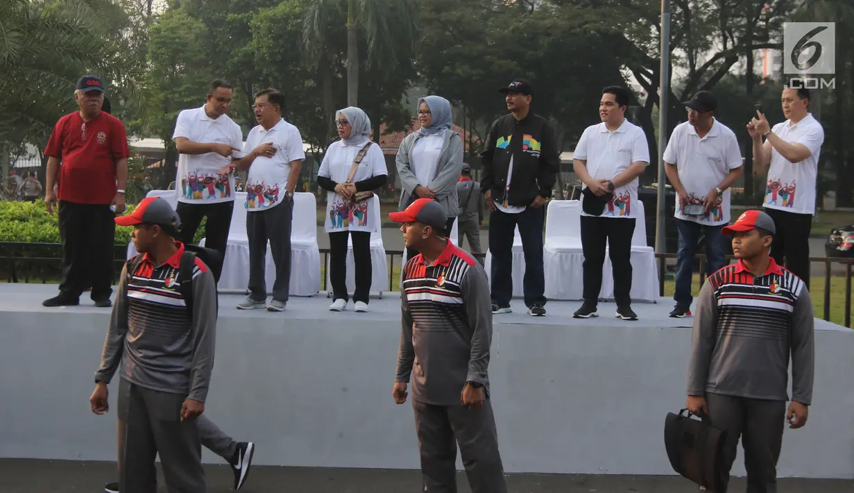 Wakil Presiden Jusuf Kalla berbincang dengan Gubernur DKI Anies Baswedan saat melepas parade Asian Games 2018 di Monas, Jakarta, Minggu (13/5). Parade Asian Games 2018 digelar di dua kota, Jakarta dan Palembang. (Liputan6.com/Arya Manggala)