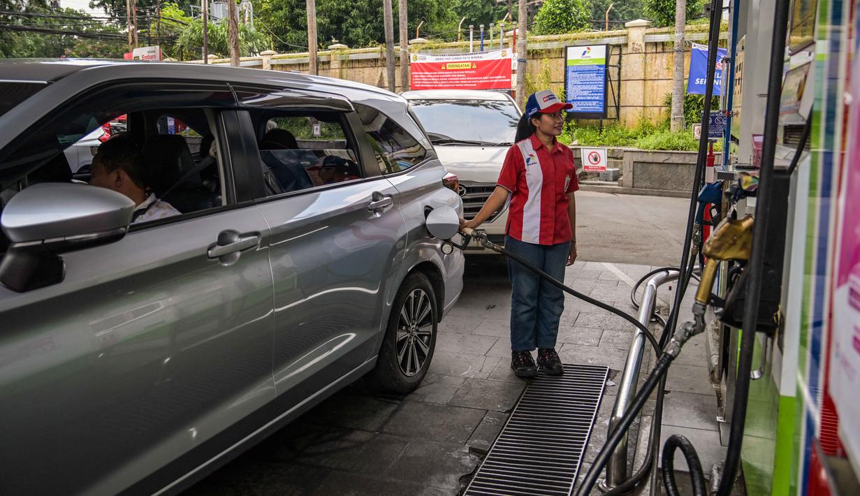 Sebagai informasi, kenaikan harga minyak mentah dunia terjadi di tengah memanasnya konflik di Timur Tengah yang menyebabkan terganggunya jalur pasokan energi global. Tmapak dalam foto, seorang karyawan mengisi bensin di sebuah Stasiun Pengisian Bahan Bakar Umum (SPBU) di Surabaya, Jawa Timur, pada Senin 9 Maret 2026. (JUNI KRISWANTO/AFP)