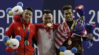 Lifter Eko Yuli (tengah) melakukan selebrasi saat mendapatkan medali emas SEA Games 2019 cabang angkat besi nomor 61 kg di Stadion Rizal Memorial, Manila, Minggu (1/12). Dirinya meraih emas dengan total angkatan 309 kg. (Bola.com/M Iqbal Ichsan)