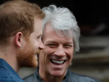 Pangeran Harry (kiri) berbincang dengan penyanyi AS, Jon Bon Jovi setibanya di Abbey Road Studios, London, Jumat (28/2/2020). Pentolan Bon Jovi dan Pangeran Harry akan bertemu dengan paduan suara Invictus Games untuk merekam lagu untuk amal. (Tolga AKMEN / AFP)