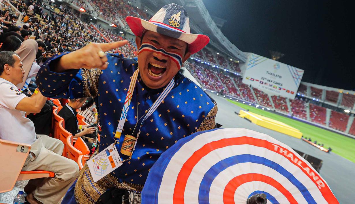 Sementara, posisi satu dihuni tuan rumah Thailand dengan 233 emas, 154 perak, dan 112 perunggu. Tampak dalam foto, salah satu pendukung tim negeri gajah putih sesaat sebelum menyaksikan upacara penutupan SEA Games 2025 di Rajamangala Stadium, Bangkok, Thailand, Sabtu (20/12/2025). (Bola.com/Bagaskara Lazuardi)