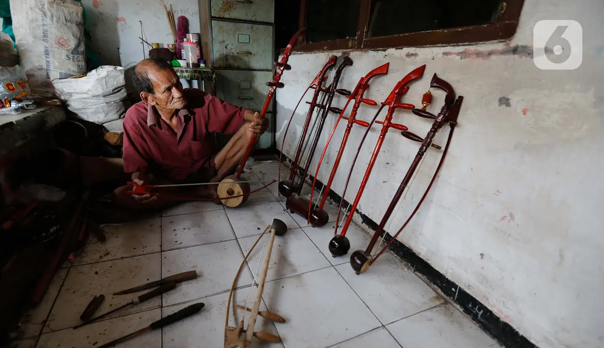 Ghohyong mengecek alat musik Tehyan buatannya di Neglasari, Kota Tangerang (5/2/2021). Ghohyong merupakan pria tua yang ahli membuat dan mahir memainkan alat musik Tehyan khas Tionghoa. (Liputan6.com/Angga Yuniar)