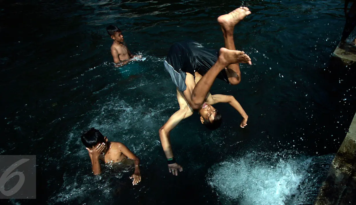 Seorang bocah melompat ke kolam pemandian Umbul Saren di Wedomartani, Sleman, Minggu (5/6). Pengunjung memadati kolam pemandian tersebut untuk melaksanakan tradisi "padusan" menjelang Ramadan 2016. (Liputan6.com/Boy Harjanto)