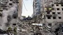 Tim penyelamat Ukraina melakukan pencarian dan penyelamatan di sebuah bangunan tempat tinggal yang rusak parah setelah serangan rudal Rusia di Kyiv pada tanggal 17 Juni 2025, di tengah invasi Rusia ke Ukraina. (Genya SAVILOV/AFP)