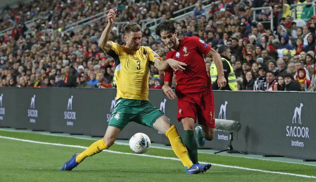 Penyerang Portugal, Goncalo Paciencia berusaha melewati pemain Lithuania, Markus Palionis pada pertandingan Grup B Kualifikasi Piala Eropa 2020 di stadion Algarve di luar Faro, Portugal (14/11/2019). Portugal menang besar 6-0 atas Lithuania. (AP Photo/Armando Franca)