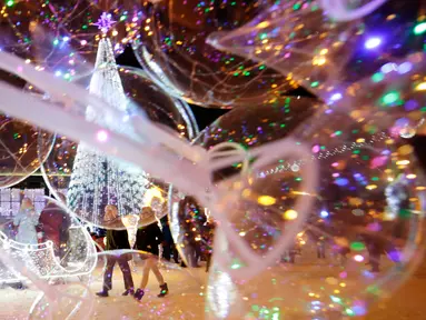 Sebuah pohon tahun baru dipajang di Octyabrskaya Square dan dekorasi untuk menyambut perayaan Natal 2018 dan Tahun Baru 2019 di Minsk, Belarus, Selasa (18/12). (AP Photo/Sergei Grits)