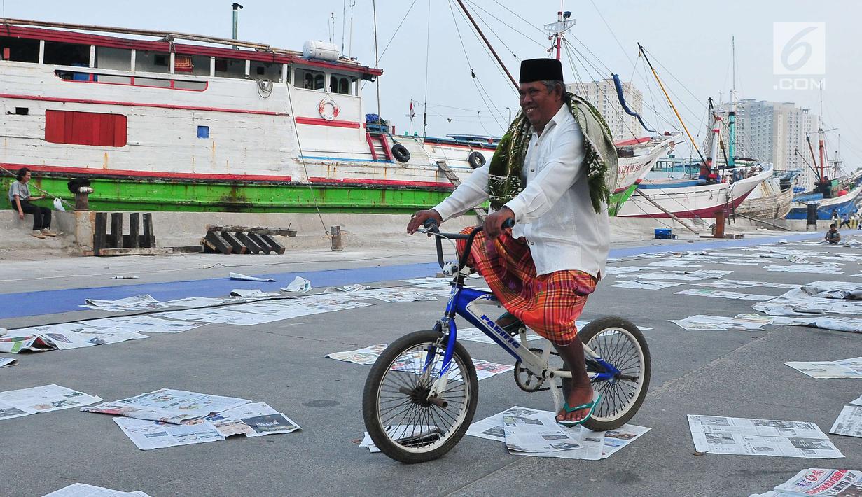 Umat muslim bersepeda usai menjalankan Salat Idul Adha 1438 H di kawasan Pelabuhan Sunda Kelapa, Jakarta, Jumat (1/9). Setelah menjalankan salat, umat muslim melakukan penyembelihan hewan kurban. (Liputan6.com/Helmi Afandi)