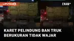 Sebuah truk menggunakan karet pelindung ban belakang melintas di jalan