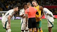 Pemain dari Arab Saudi bereaksi terhadap wasit dan pemain Australia Jackson Irvine (kedua dari kanan) setelah gol dianulir dalam pertandingan kualifikasi Piala Dunia 2026 antara Australia dan Arab Saudi di Stadion Melbourne Rectangular di Melbourne, Kamis (14/11/2024). (WILLIAM WEST/AFP)