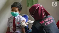 Seorang murid sekolah dasar menerima vaksinasi COVID-19 di SDN 04 Pagi Cilandak Barat, Jakarta, Selasa (14/12/2021). Pada tahap pertama, vaksinasi COVID-19 untuk anak usia 6-11 tahun dilakukan di 106 kabupaten/kota di 11 provinsi di Indonesia. (Liputan6.com/Faizal Fanani)