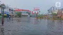 Seorang pria menerobos banjir yang mengepung Kota Semarang, Jawa Tengah, Sabtu (6/2/2021). Hujan deras sejak Jumat malam hingga Sabtu pagi, 6 Februari 2021 membuat sejumlah kawasan di Kota Semarang dikepung banjir. (Liputan6.com/Gholib)