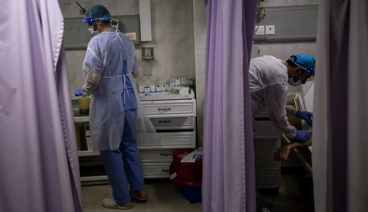 Dokter Palestina merawat pasien di ruang gawat darurat Rumah Sakit al-Quds, di Kota Gaza, 7 September 2020. Lusinan petugas kesehatan garis depan telah terinfeksi COVID-19, memberikan pukulan baru ke rumah sakit yang kelebihan beban. (AP Photo/Khalil Hamra)