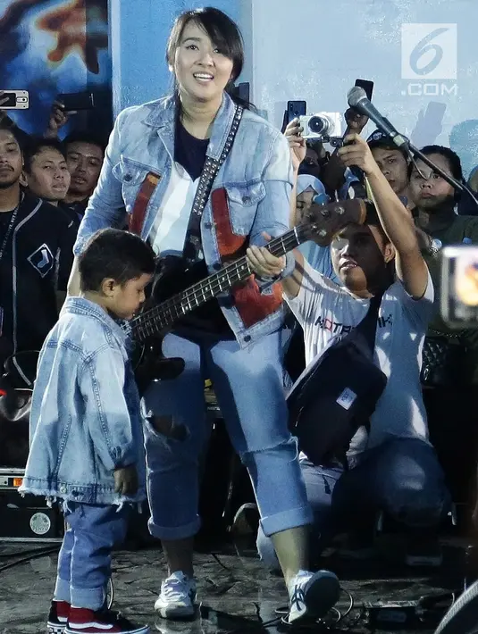 Basis Band Kotak Chua bersama putranya saat tampil dalam Road to Playfest 2019 di Terowongan Kendal, Jakarta (26/7/2019). Lagu Terbang mengawali penampilan Band Kotak sekitar pukul 18.30 WIB. (Fimela.com/Bambang E. Ros)