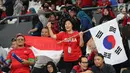 Dua suporter memberi dukungan kepada tim bola voli putra Indonesia dan Korea Selatan dalam babak perempat final bola voli putra Asian Games 2018 di Volley Indoor Jakarta, Selasa (28/8). (Liputan6.com/Fery Pradolo)