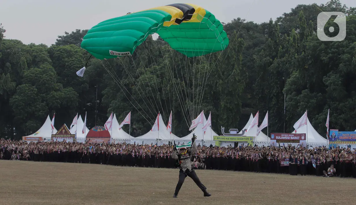 Pasukan TNI AD saat aksi terjun payung saat Peringatan Hari Pramuka ke-62 tahun dan pembukaan Raimuna Nasional (Rainas) XII Tahun 2023 di Bumi Perkemahan dan Graha Wisata Pramuka (Buperta), Cibubur, Jakarta, Senin (14/8/2023). (Liputan6.com/Herman Zakharia)