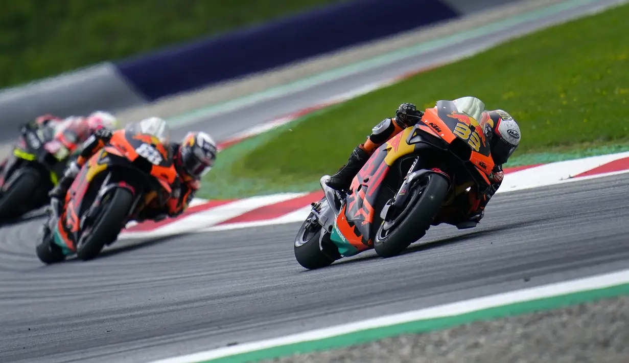 Disaat pembalap lain memasuki pit stop untuk mengganti motor, Brad Binder mengambil resiko untuk tetap menggunakan motor dengan ban kering di situasi hujan. Keputusan yang sangat gambling itu terbayarkan dengan lunas. (Foto: AP/Steve Wobser)