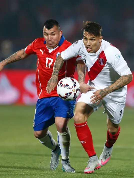Penyerang Peru, Paolo Guerrero (kanan) berusaha melewati pemain Chili, Gary Medel saat semifinal Copa Amerika 2015 di National Stadium, Santiago, Chili, (29/6/2015). Chili melaju ke final usai mengalahkan Peru 2-1. (REUTERS/Marcos Brindicci)