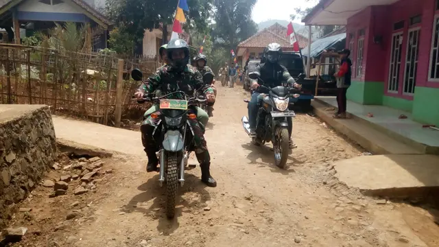 Beberapa petugas TNI melakukan pengecekan saat melakukan kerja bakti bersama warga