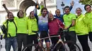 Pembalap sepeda Inggris, Mark Beaumont (34) berpose bersama ibu dan anggota timnya saat tiba di Arc de Triomphe, Paris, setelah menyelesaikan tur keliling dunia selama 78 hari, Senin (18/9). (CHRISTOPHE ARCHAMBAULT / AFP)