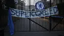 Sebuah spanduk terpasanng pada salah satu gerbang Stadion Stamford Bridge saat fans Chelsea melakukan aksi protes menentang keputusan Chelsea ikut serta dalam pembentukan Liga Super Eropa di luar Stadion Stamford Bridge, London, Inggris, Selasa (20/4/2021). (AP Photo/Matt Dunham)