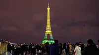 Pemandangan saat Menara Eiffel berhias instalasi cahaya warna kuning di Paris, Perancis, Kamis (13/9). Pertunjukan ini untuk merayakan 160 tahun hubungan diplomatik antara Perancis dengan Jepang. (AP Photo/Christophe Ena)
