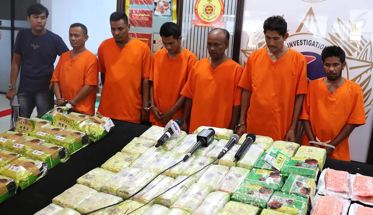 Tersangka beserta barang bukti kasus narkotika jaringan Malaysia-Sumatera saat rilis di Jakarta, Senin (4/2). Polisi menyita 16 Kg sabu, 50 Kg kristal putih, 15 ribu butir pil ekstasi, sebungkus H-5, serta empat mobil. (Liputan6.com/Immanuel Antonius)