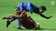 Pemain sayap Timnas Indonesia U-23, Riko Simanjuntak (bawah) berebut bola dengan pemain Thailand U-23, Chaiyawat Buran pada laga persahabatan di Stadion Pakansari, Kab Bogor, Minggu (3/6). Laga berakhir imbang 0-0. (Liputan6.com/Helmi Fithriansyah)