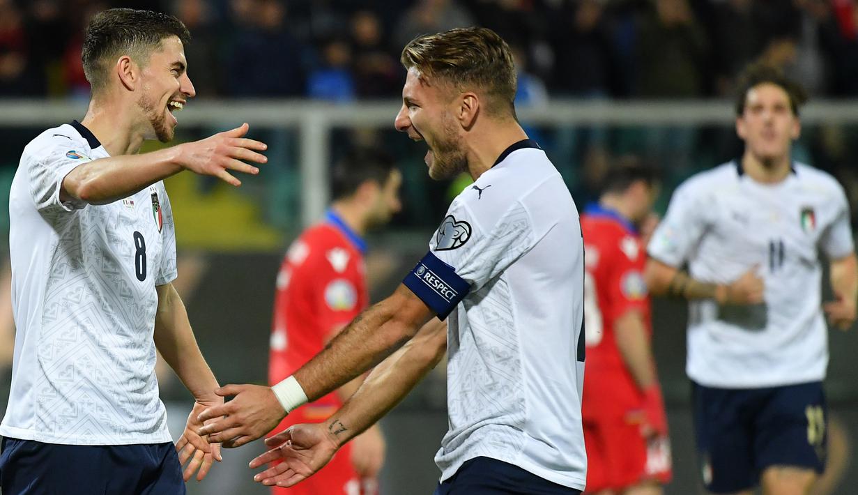 Gelandang Italia, Jorginho, merayakan gol yang dicetak Ciro Immobile ke gawang Armenia pada laga Kualifikasi Piala Eropa 2020 di Stadion Renzo Barbera, Palermo, Senin (18/11). Italia menang 9-1 atas Armenia. (AFP/Andreas Solaro)
