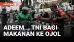 Sejumlah aparat TNI dari Kodim 0734 menghentikan pengendara, terutama ojek online, bukan untuk razia, tapi untuk membagikan bingkisan makan siang.
