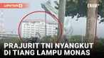Viral! Penerjung Payung TNI Nyangkut di Tiang Lampu Monas