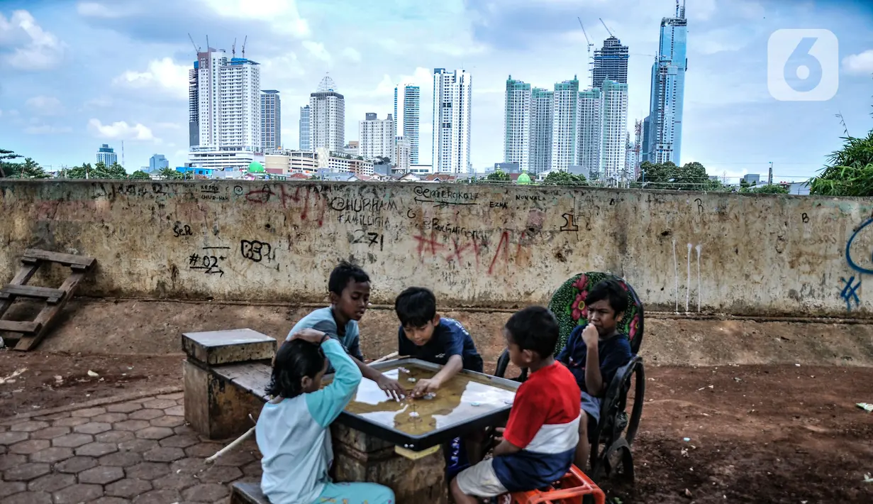 Anak-anak saat bermain dengan latar belakang gedung bertingkat di kawasan Petamburan, Jakarta, Selasa (23/11/2021). Menteri Keuangan Sri Mulyani Indrawati menyebutkan realisasi pendapatan negara pada Januari-Oktober 2021 naik 18,2 persen year on year (yoy). (merdeka.com/Iqbal S. Nugroho)