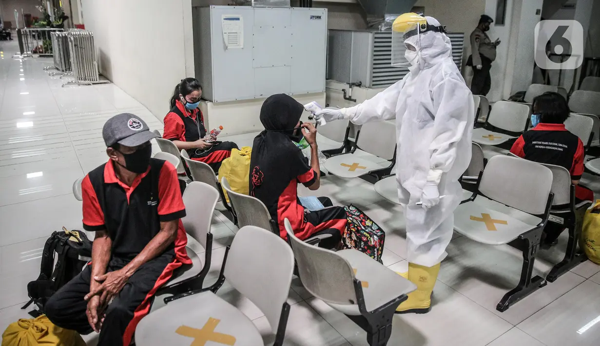 Sejumlah TKI Ilegal yang dipulangkan dari Malaysia diukur suhu tubuhnya setibanya di Pelabuhan Tanjung Priok, Jakarta, Jumat (12/6/2020). Sebanyak 436 TKI Ilegal tersebut nantinya akan dipulangkan ke daerah asalnya di 22 provinsi. (Liputan6.com/Faizal Fanani)