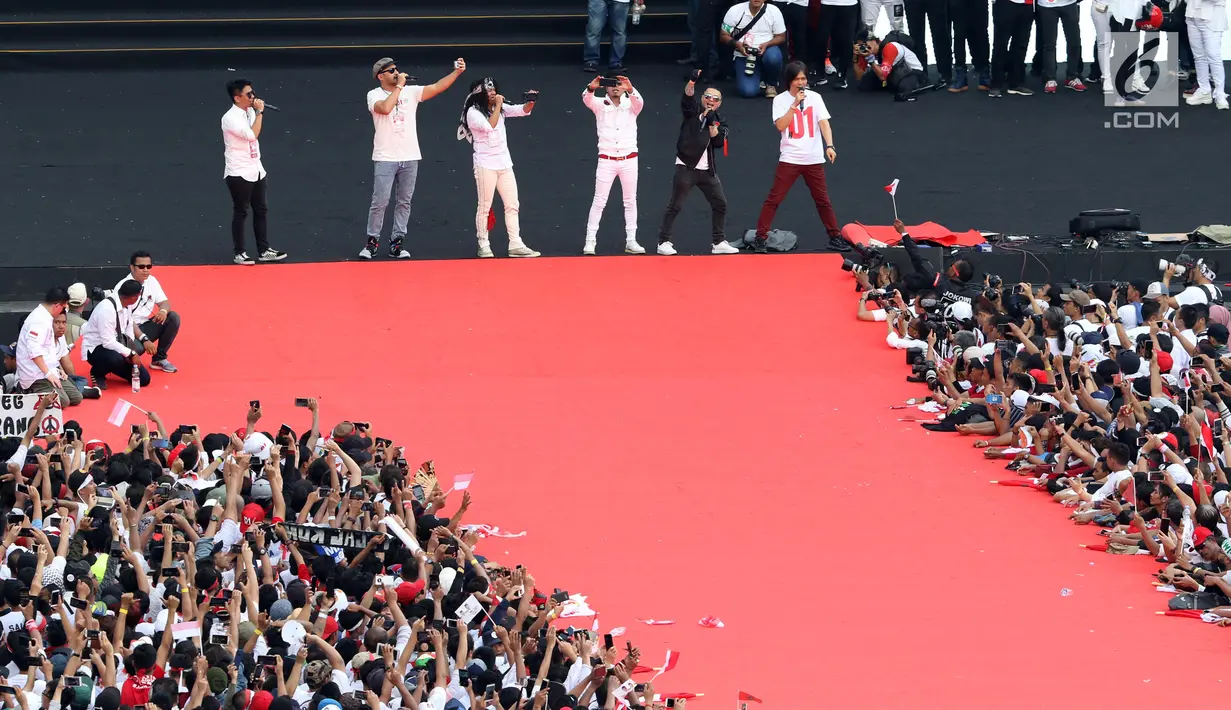 Sejumlah musisi dan artis ibukota membawakan lagu pada kampanye akbar capres dan cawapres Joko Widodo (Jokowi)-Ma'ruf Amin di Stadion Utama GBK, Senayan, Jakarta, Sabtu (13/15). Penampilan kolaborasi dari 100 gitaris Indonesia meramaikan pagelaran Konser Putih Bersatu. (Liputan6.com/Angga Yuniar)